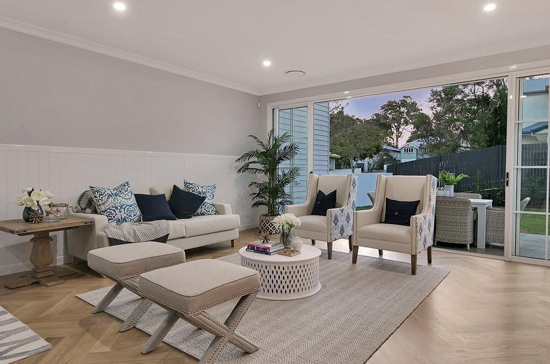 Newly renovated living room interior with neutral colour scheme and sliding doors to garden.